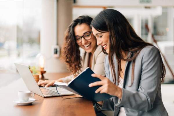 Two women working together