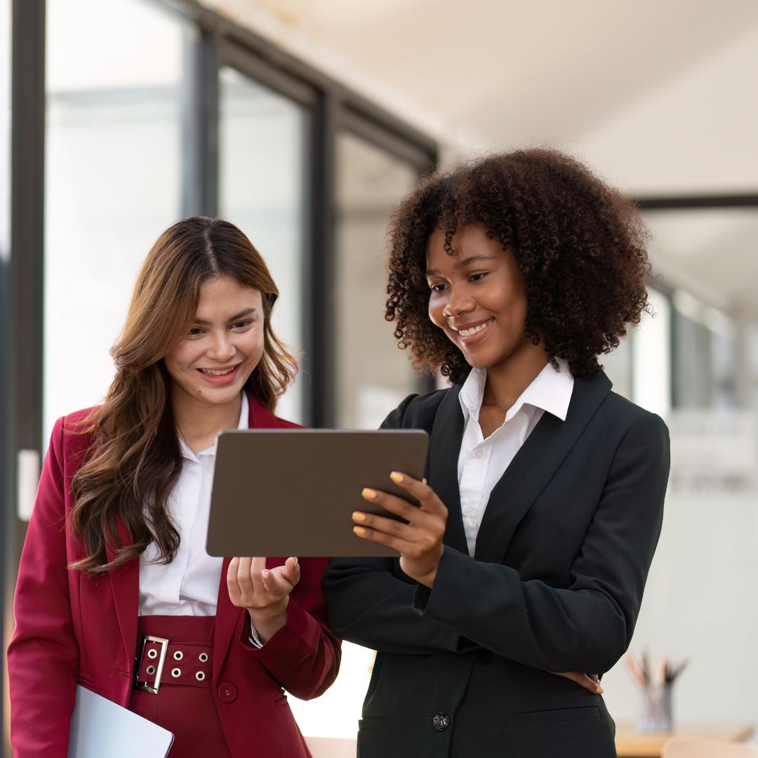 Two professional woman looking at ipad together